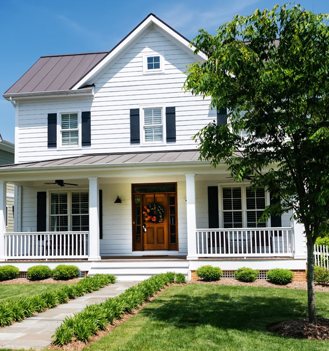 home with new vinyl siding and metal roofing